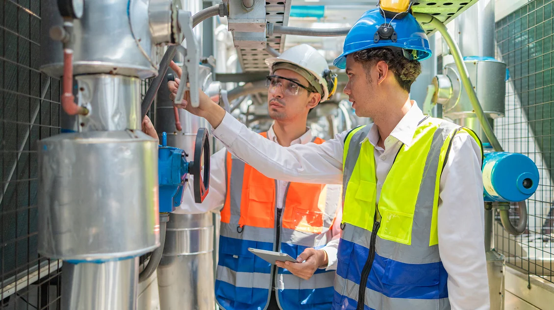 Technicians inspecting building equipment to reduce emergency repair costs