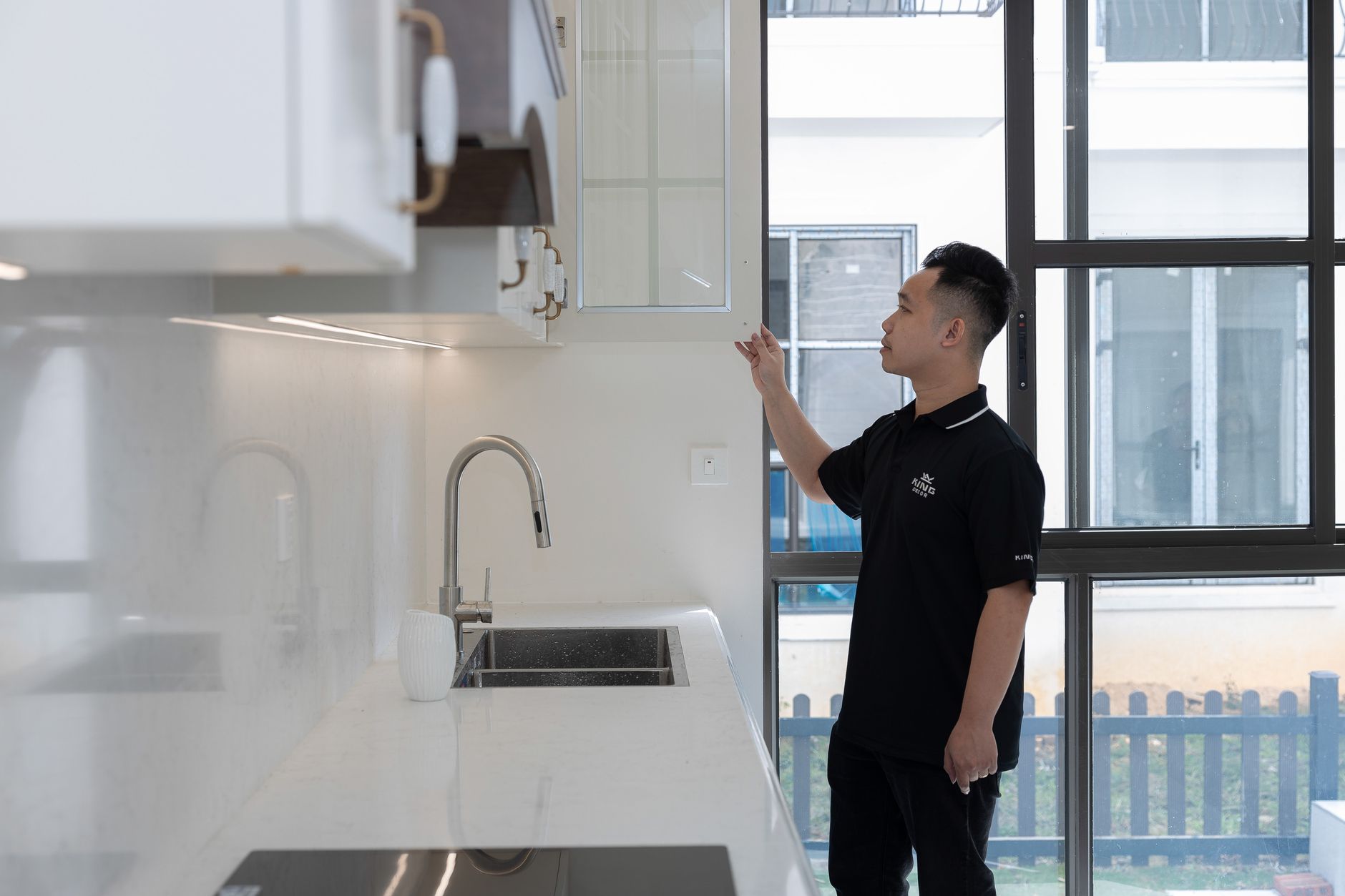 Contractor inspecting kitchen cabinets during an apartment unit renovation