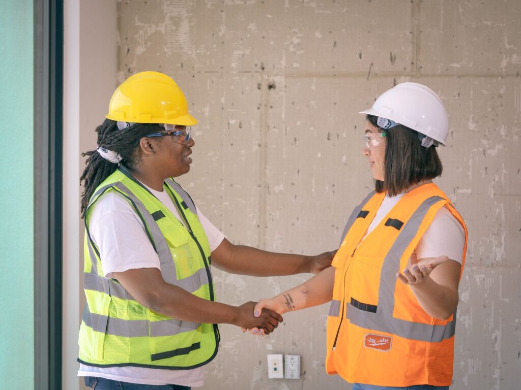 Property manager and maintenance contractor shaking hands after signing a service agreement